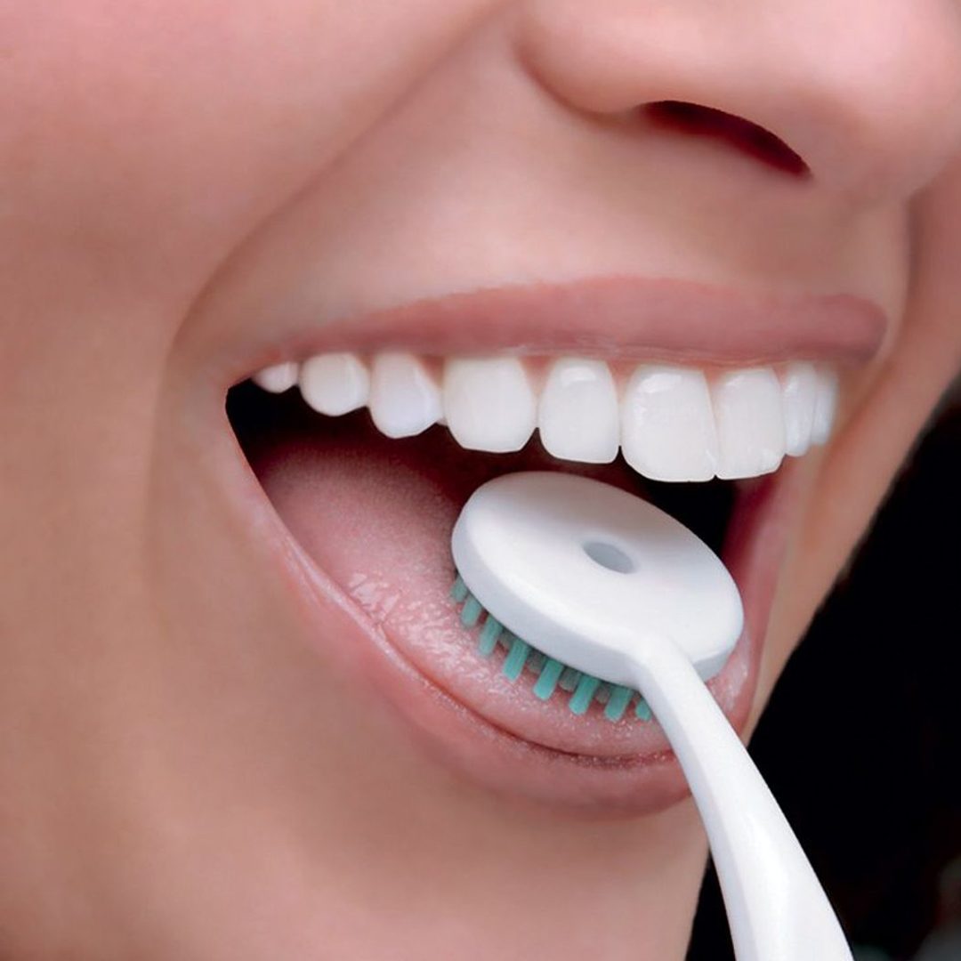 The TUNG Brush cleaning the surface of a tongue